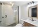 Updated bathroom features tiled shower with glass door, modern vanity, mirror, and lighting at 21434 E Greenwood Pl, Aurora, CO 80013