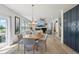 Bright dining room with modern lighting, neutral palette, and views of the adjacent living space at 21434 E Greenwood Pl, Aurora, CO 80013