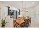 Spacious dining room with a hardwood table, modern chandelier, and beautiful archway at 21434 E Greenwood Pl, Aurora, CO 80013
