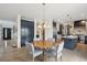 Cozy dining area showcasing a round table, modern lighting, and seamless access to the kitchen at 21434 E Greenwood Pl, Aurora, CO 80013