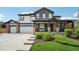 Charming two-story home with a well-manicured lawn and inviting covered front porch at 21434 E Greenwood Pl, Aurora, CO 80013