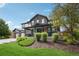Attractive two-story home with a welcoming covered porch and lush landscaping at 21434 E Greenwood Pl, Aurora, CO 80013