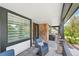 Cozy covered front porch with stylish seating area and brick accents is perfect for relaxing outdoors at 21434 E Greenwood Pl, Aurora, CO 80013