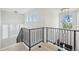Elegant hallway featuring modern lighting and sleek black railing at 21434 E Greenwood Pl, Aurora, CO 80013