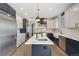 Spacious kitchen boasts stainless steel appliances, a large island, and stylish pendant lighting at 21434 E Greenwood Pl, Aurora, CO 80013
