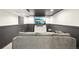 Entertainment space featuring a comfortable sofa, TV, and stylish black and white decor at 21434 E Greenwood Pl, Aurora, CO 80013