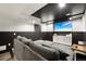 Relaxing living room featuring a plush gray sectional sofa and large TV at 21434 E Greenwood Pl, Aurora, CO 80013