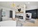 Luxurious primary bedroom with a marble fireplace, plush seating, and warm natural light at 21434 E Greenwood Pl, Aurora, CO 80013