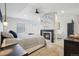 Cozy primary bedroom with a modern fireplace, neutral tones, and large windows that provide great light at 21434 E Greenwood Pl, Aurora, CO 80013