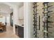 Elegant wine bar with built-in storage and a stone-accented, glass-enclosed wine rack at 21434 E Greenwood Pl, Aurora, CO 80013