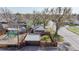 Aerial view of a charming home with a fenced yard, detached garage, and mature trees at 7785 E 13Th Ave, Denver, CO 80220