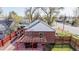 Backyard with brick patio, pergola with seating, fenced yard and partial view of roof at 7785 E 13Th Ave, Denver, CO 80220