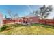 Well-kept backyard with a wooden pergola, a small patio, and a privacy fence at 7785 E 13Th Ave, Denver, CO 80220