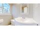 Bright bathroom features a sink with a vanity and a stained glass window that provides soft, natural light at 7785 E 13Th Ave, Denver, CO 80220