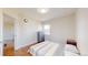 Cozy bedroom with neutral tones and warm wood floors at 7785 E 13Th Ave, Denver, CO 80220