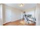 Office/bedroom with wood floors, two closets, and an open doorway to another room at 7785 E 13Th Ave, Denver, CO 80220