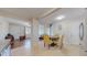 Eat-in kitchen featuring a round table and a seamless transition into living room and updated kitchen at 7785 E 13Th Ave, Denver, CO 80220