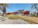 Charming bungalow-style home with a well-maintained lawn and a modern wooden fence at 7785 E 13Th Ave, Denver, CO 80220