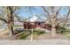 Charming home with mature trees, privacy fencing, and well-kept landscaping at 7785 E 13Th Ave, Denver, CO 80220