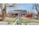 Charming single-story brick home with a well-manicured front yard, walkway, and privacy fence at 7785 E 13Th Ave, Denver, CO 80220