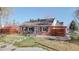 Attractive brick house with a neat front yard, complemented by modern wood fence and a stone-lined walkway at 7785 E 13Th Ave, Denver, CO 80220