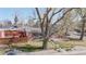 Beautiful brick home showcasing a well-manicured lawn, a stone-lined walkway, and a modern horizontal fence at 7785 E 13Th Ave, Denver, CO 80220