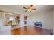 Open-concept living room with hardwood floors and a view of dining area and updated kitchen at 7785 E 13Th Ave, Denver, CO 80220