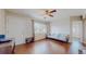 Cozy living room featuring hardwood floors, a window with natural light, and a neutral color scheme at 7785 E 13Th Ave, Denver, CO 80220