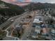Twilight aerial view showcases the town's vibrant urban landscape and layout at 2041 Virginia St, Idaho Springs, CO 80452