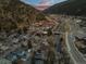 Panoramic aerial view of a quaint mountain town nestled amidst lush green hills and river at 2041 Virginia St, Idaho Springs, CO 80452