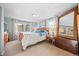 Bright bedroom with light blue walls, a wooden sleigh bed, and two windows with patterned curtains at 2041 Virginia St, Idaho Springs, CO 80452