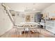 Inviting dining area with a large table, tile flooring, and steps leading to another level at 2041 Virginia St, Idaho Springs, CO 80452