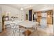Bright dining room offering a long table with seating, tiled flooring, and adjacent kitchen area at 2041 Virginia St, Idaho Springs, CO 80452