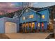 Charming blue two-story home with a detached garage, well-lit windows, and a cozy red front door at 2041 Virginia St, Idaho Springs, CO 80452