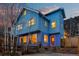 Attractive blue two-story home with large windows and a red front door, framed by trees and mountain views at 2041 Virginia St, Idaho Springs, CO 80452