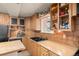 Inviting kitchen area showcases wooden cabinetry, dual sinks, and a view through a window above at 2041 Virginia St, Idaho Springs, CO 80452