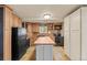 Charming kitchen with warm wood cabinets, black appliances, a functional island and decorative backsplash at 2041 Virginia St, Idaho Springs, CO 80452