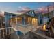 Inviting covered porch with a fire pit, stone pathway, and railing offering relaxing outdoor space at 2041 Virginia St, Idaho Springs, CO 80452