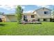 Exterior view of a home featuring a wooden deck and green lawn at 235 Summit Cir, Lafayette, CO 80026