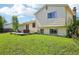 Exterior view of a home with a green lawn and wooden deck at 235 Summit Cir, Lafayette, CO 80026