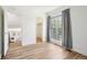 Bright bedroom showcasing hardwood floors, white walls, large windows, and closet at 235 Summit Cir, Lafayette, CO 80026