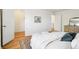 Bright bedroom featuring light hardwood floors, white walls, and a cozy rug at 235 Summit Cir, Lafayette, CO 80026