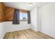 Well-lit bedroom with hardwood floors and neutral-toned walls, providing a simple and airy atmosphere at 235 Summit Cir, Lafayette, CO 80026
