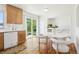 Dining space with hardwood floors, white appliances, and sliding glass door to outdoors at 235 Summit Cir, Lafayette, CO 80026