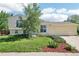 Charming two-story home with a well-maintained lawn and a two car garage at 235 Summit Cir, Lafayette, CO 80026