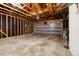 Spacious garage featuring exposed wooden beams and a gray garage door at 235 Summit Cir, Lafayette, CO 80026