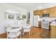Bright kitchen with hardwood floors, white appliances, and a modern dining set at 235 Summit Cir, Lafayette, CO 80026
