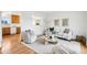 Cozy living room with hardwood floors, neutral decor, and open kitchen view at 235 Summit Cir, Lafayette, CO 80026