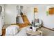 Open-concept living space with hardwood floors, staircase access, and natural light at 235 Summit Cir, Lafayette, CO 80026