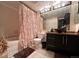 Bathroom with a unique vanity, tiled floor, and decorative shower curtain at 4933 S Carson St # 212, Aurora, CO 80015
